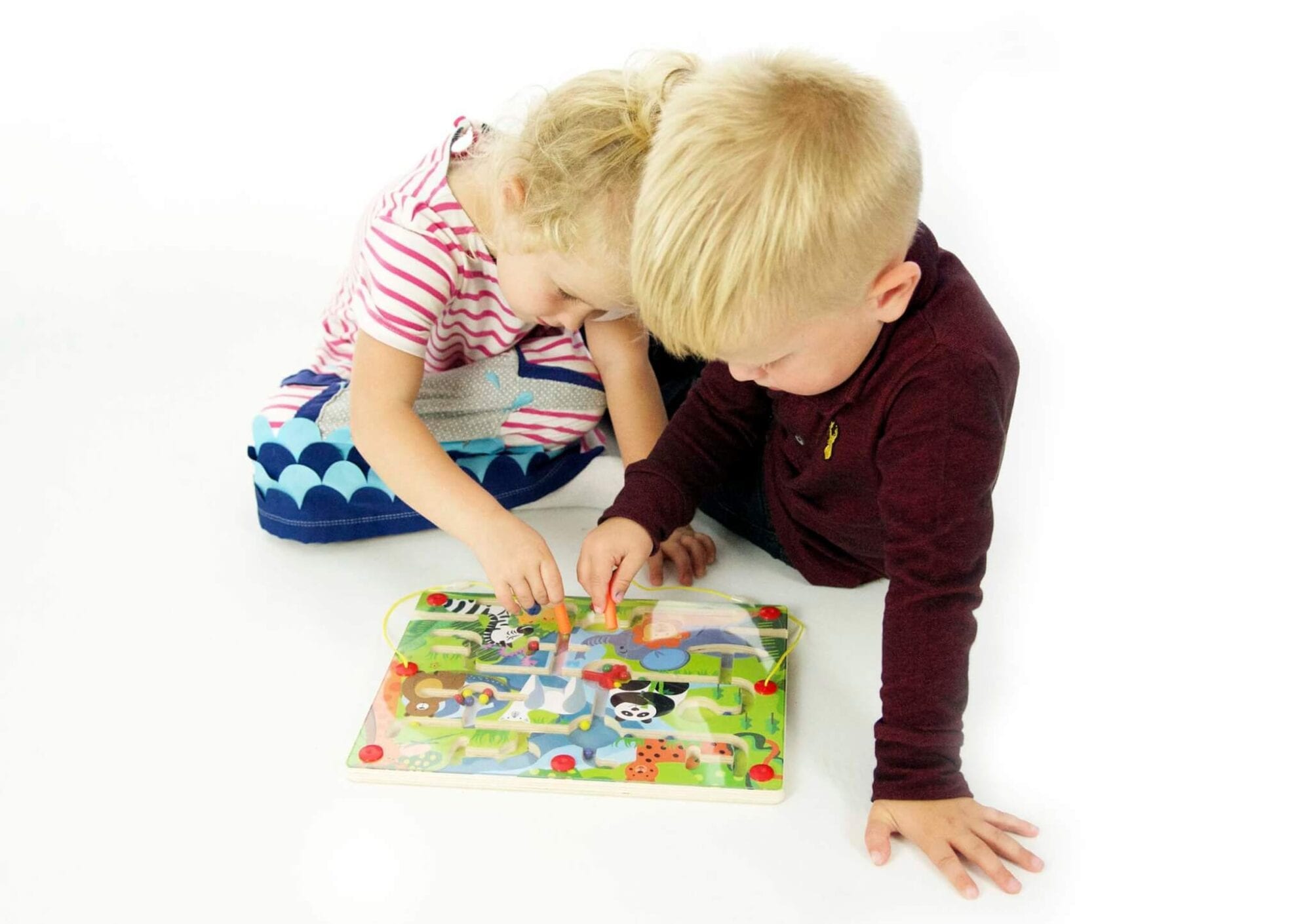 Children playing with magnetic farm maze