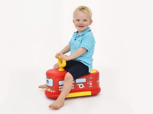 Child playing with ride on fire engine
