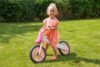 Pink wooden balance bike