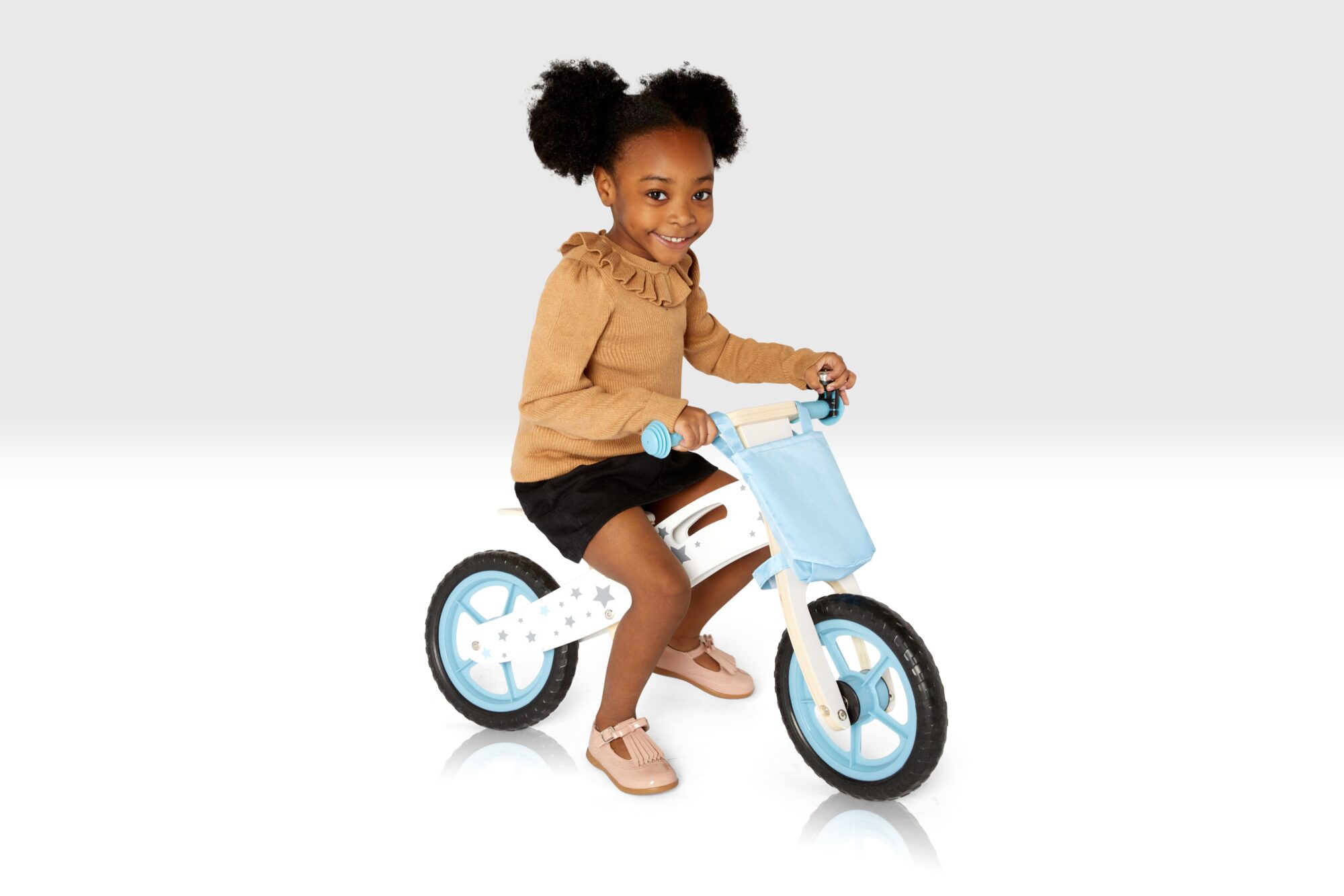 blue balance bike with girl